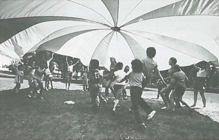 Children and supervisors enjoying a parachute game at Vimy Ridge Park (1980)