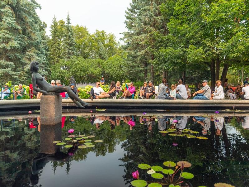 People sitting by one of Leo Mol's statues
