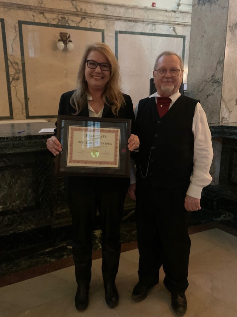 Cindy Tugwell (Executive Director) and Greg Agnew (President) accepting the certificate on behalf of Heritage Winnipeg. Congratulations!